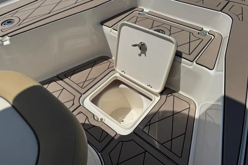 Slide: The Image of 2019 Key West 230 Bay Reef boat with open storage compartment on deck. - 104