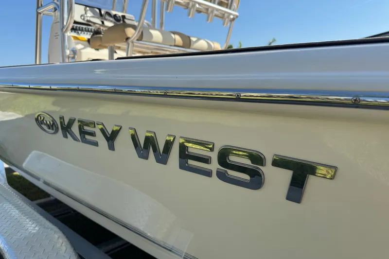 Slide: The Image of 2019 Key West 230 Bay Reef boat with chrome logo detail. - 13