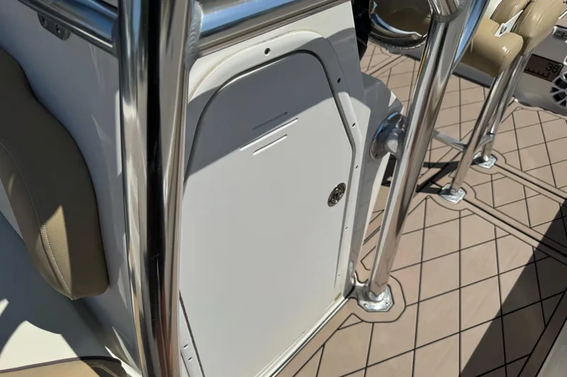 Slide: The Image of 2019 Key West 230 Bay Reef boat interior with stainless steel railings and storage compartment. - 131
