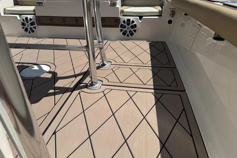 Slide: The Image of 2019 Key West 230 Bay Reef boat deck with geometric pattern and stainless steel fittings. - 133