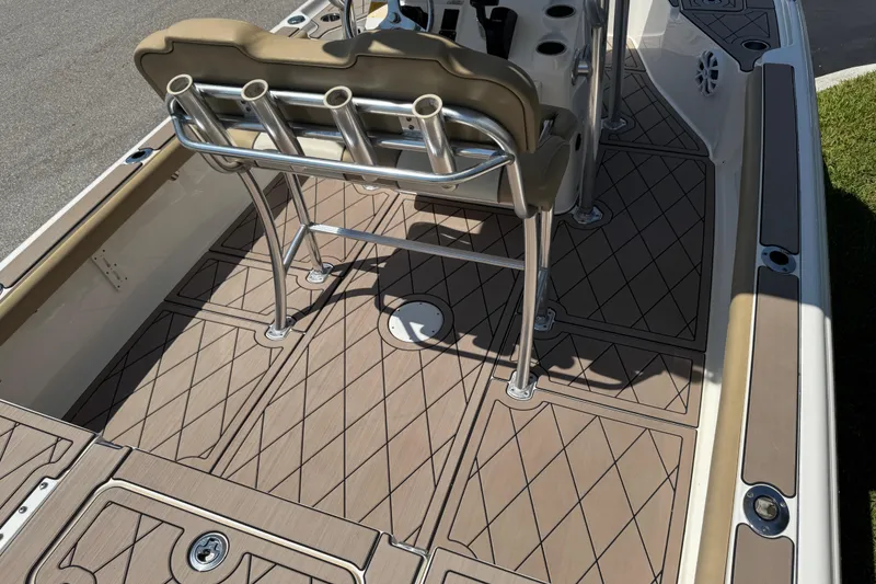Slide: The Image of 2019 Key West 230 Bay Reef boat interior with rod holders and diamond-patterned flooring. - 136