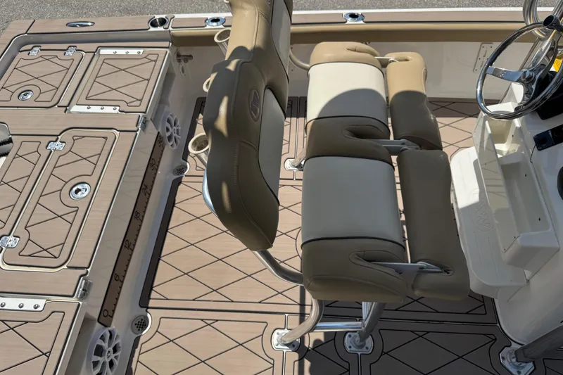 Slide: The Image of 2019 Key West 230 Bay Reef boat interior with cushioned seating and deck storage. - 137