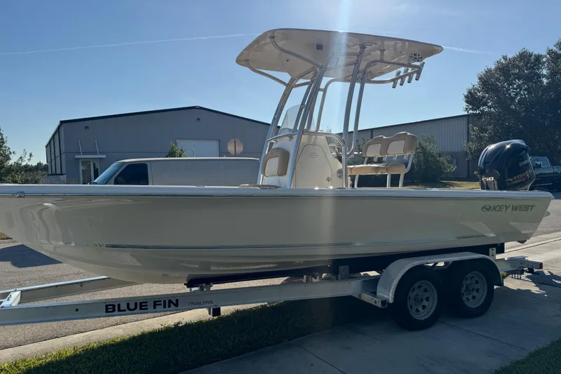 Slide: The Image of 2019 Key West 230 Bay Reef boat on Blue Fin trailer, parked outdoors. - 14