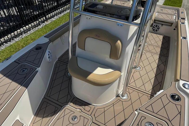 Slide: The Image of 2019 Key West 230 Bay Reef boat interior with tan seating and deck details. - 140