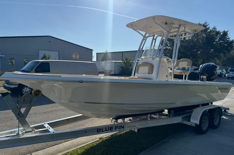 Slide: The Image of 2019 Key West 230 Bay Reef boat on trailer, parked outdoors in sunlight. - 15
