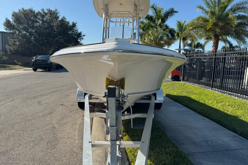 Slide: The Image of 2019 Key West 230 Bay Reef boat on trailer, parked on sunny street. - 17