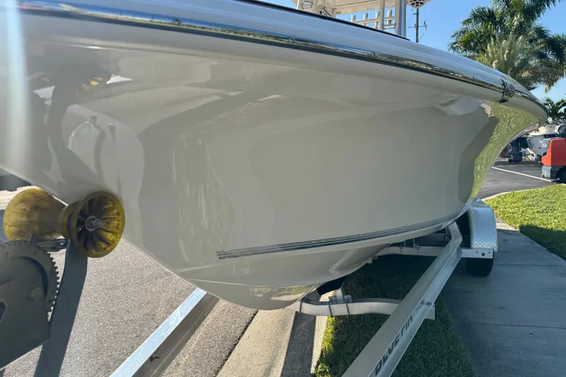 Slide: The Image of 2019 Key West 230 Bay Reef boat on trailer, side view, sunny day. - 18