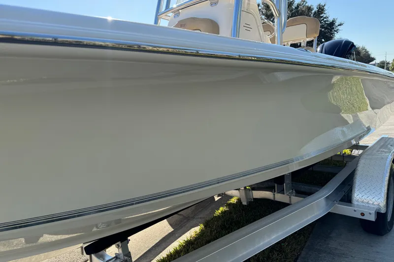 Slide: The Image of 2019 Key West 230 Bay Reef boat on trailer, side view in sunlight. - 19