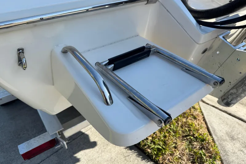 Slide: The Image of 2019 Key West 230 Bay Reef boat with foldable swim ladder on the stern. - 21