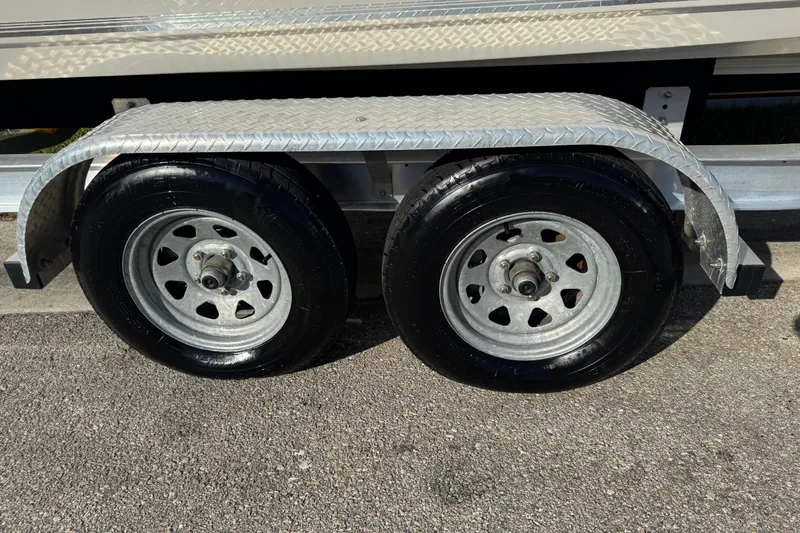 Slide: The Image of Trailer wheels of a 2019 Key West 230 Bay Reef boat on pavement. - 35