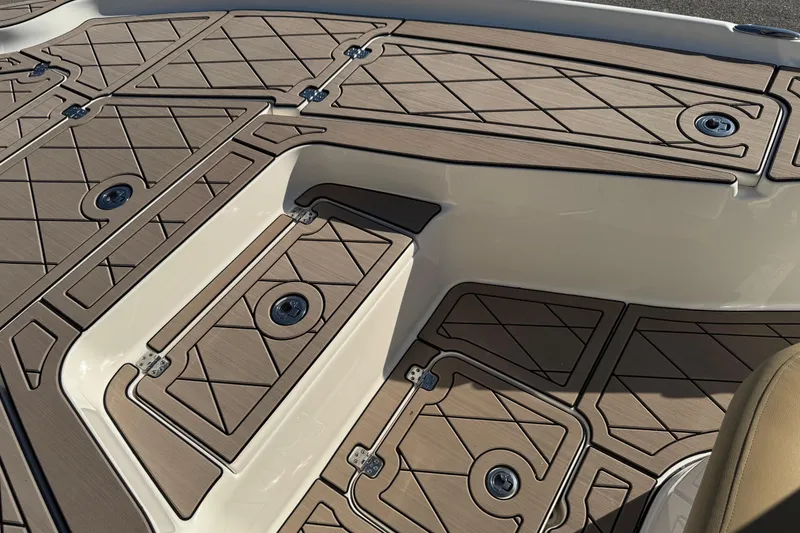 Slide: The Image of 2019 Key West 230 Bay Reef boat deck with tan non-slip surface and storage compartments. - 37