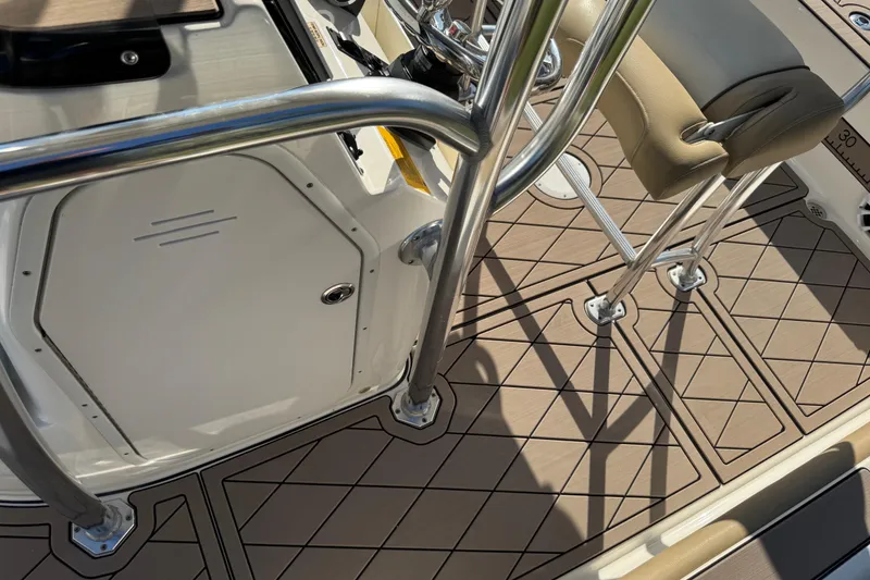 Slide: The Image of 2019 Key West 230 Bay Reef boat interior with cushioned seating and stainless steel railings. - 46