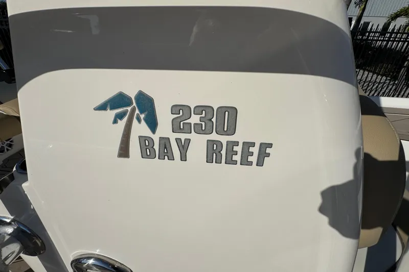 Slide: The Image of 2019 Key West 230 Bay Reef boat logo on white surface. - 61