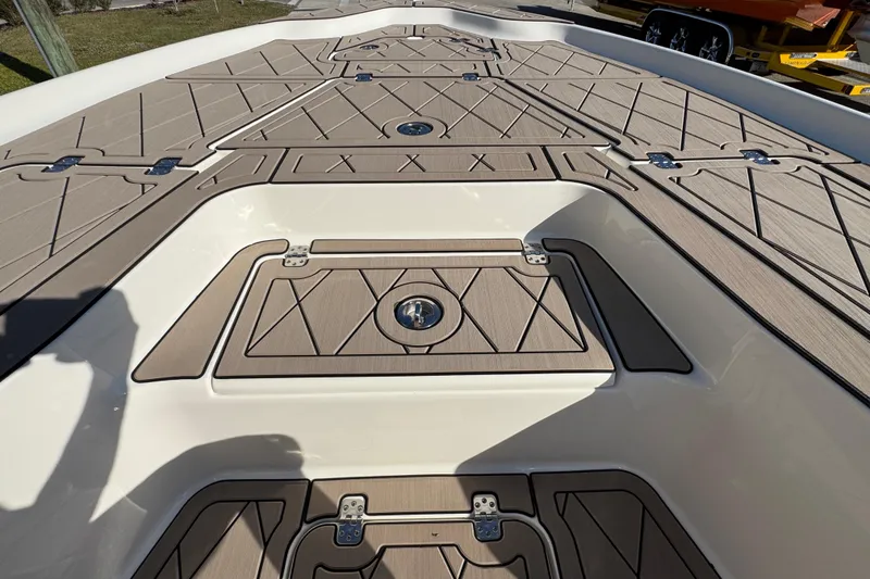 Slide: The Image of 2019 Key West 230 Bay Reef boat deck with storage compartments and textured flooring. - 64