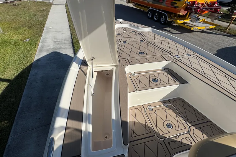 Slide: The Image of 2019 Key West 230 Bay Reef boat deck with open storage compartment. - 68