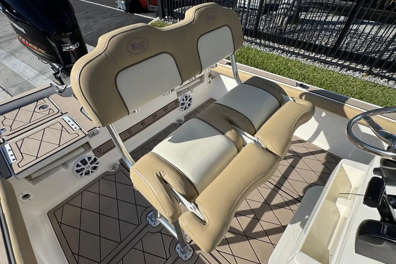 Slide: The Image of 2019 Key West 230 Bay Reef boat interior with beige seating and Yamaha 250 engine. - 73