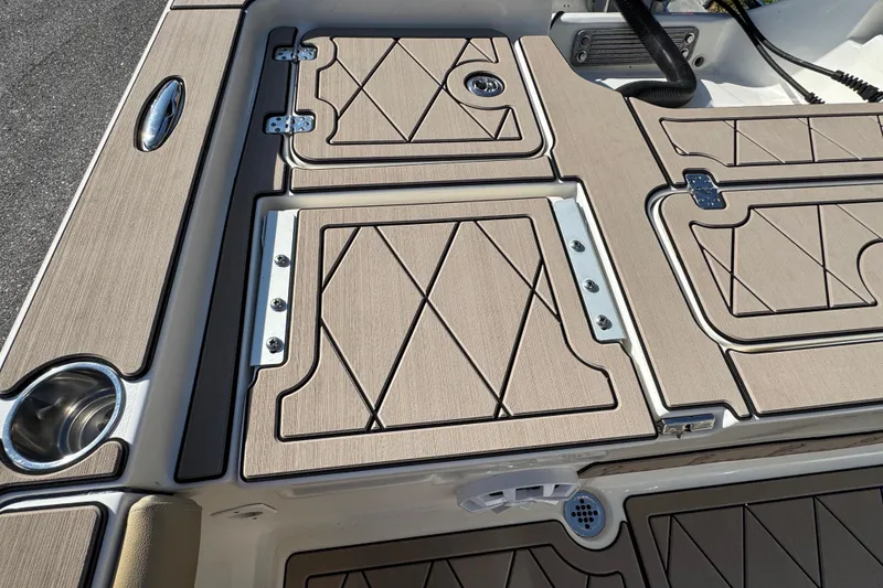 Slide: The Image of 2019 Key West 230 Bay Reef boat deck with tan non-slip surface and storage compartments. - 74