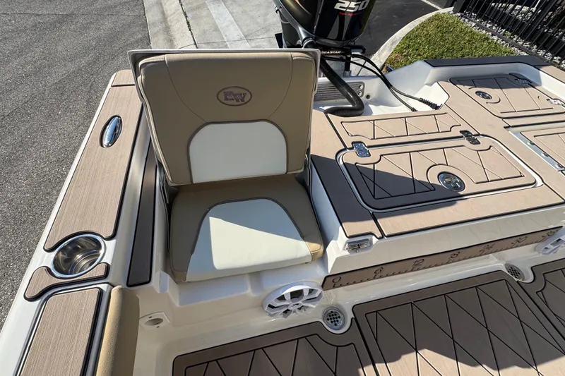 Slide: The Image of 2019 Key West 230 Bay Reef boat interior with cushioned seating and storage compartments. - 76