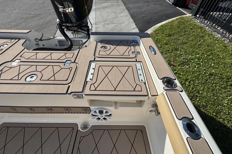 Slide: The Image of 2019 Key West 230 Bay Reef boat deck with Yamaha 250 engine, featuring storage compartments. - 77