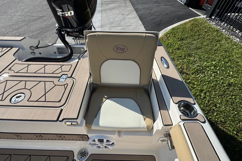 Slide: The Image of 2019 Key West 230 Bay Reef boat seat with Yamaha 250 engine, docked on grass. - 78