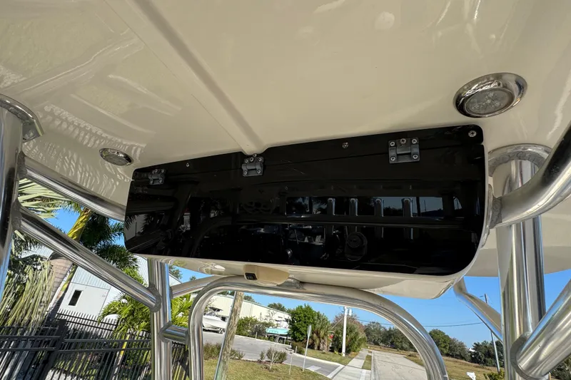 Slide: The Image of 2019 Key West 230 Bay Reef boat's T-top with mounted electronics and lighting. - 81