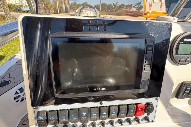 Slide: The Image of Dashboard of a 2019 Key West 230 Bay Reef boat with Garmin display and controls. - 91