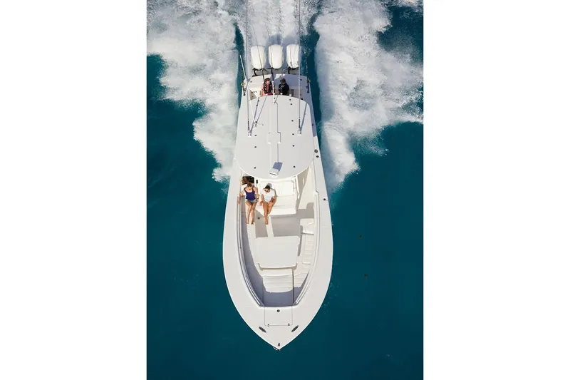 Slide: The Image of 2019 Regulator 34SS boat cockpit with dual white captain's chairs and steering console. - 14