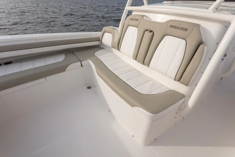 Slide: The Image of 2019 Regulator 34SS boat interior with white seating and steering wheel. - 17
