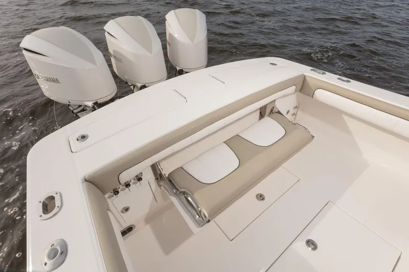 Slide: The Image of 2019 Regulator 34SS boat with white seating and canopy, docked under a clear blue sky. - 27