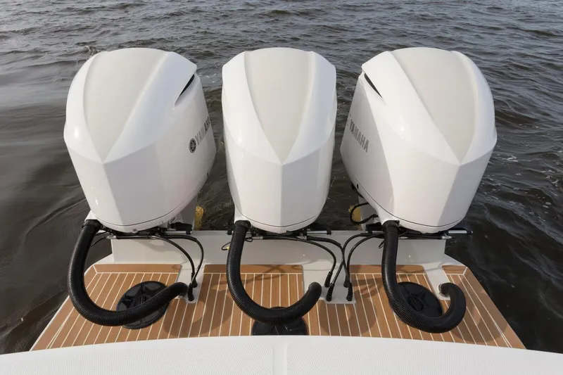 Slide: The Image of 2019 Regulator 34SS boat with white cushioned seating and sleek design. - 28