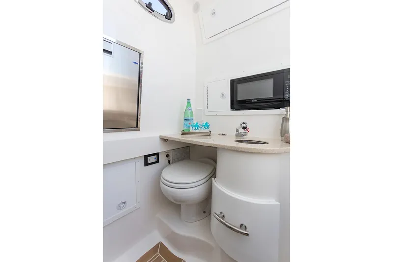 Slide: The Image of 2019 Regulator 34SS boat compartment with stainless steel fittings and secure latch. - 32