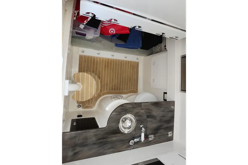 Slide: The Image of 2019 Regulator 34SS boat docked, featuring a sleek blue and white design. - 7