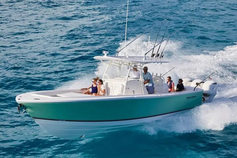 Slide: The Image of 2019 Regulator 34SS boat docked, featuring a sleek blue and white design. - 8