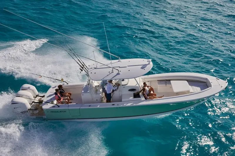 Slide: The Image of 2019 Regulator 34SS boat helm with blue T-top and rod holders. - 9