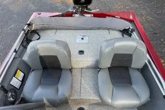 Slide: The Image of 2020 Tracker Pro 160 boat interior with two gray seats and red trim. - 4