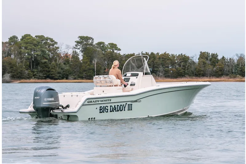 Slide: The Image of 2018 Grady-White Fisherman 236 boat on water, Yamaha engine, trees in background. - 1