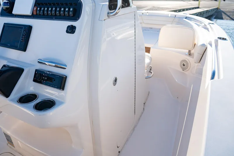 Slide: The Image of 2018 Grady-White Fisherman 236 boat console with controls and seating area. - 10
