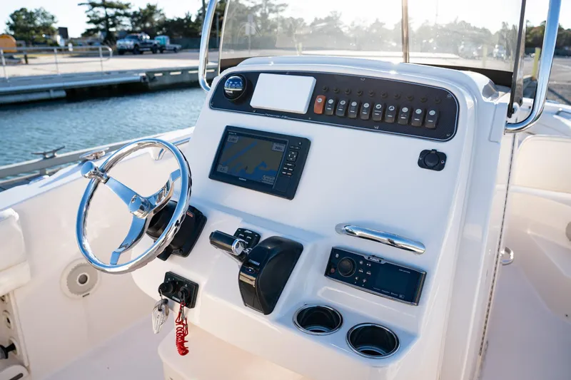 Slide: The Image of 2018 Grady-White Fisherman 236 boat console with steering wheel and navigation controls. - 5