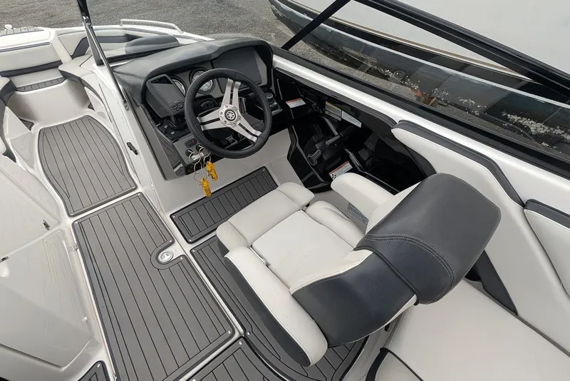 Slide: The Image of 2017 Yamaha 242 Limited S boat interior with steering wheel and seating. - 11