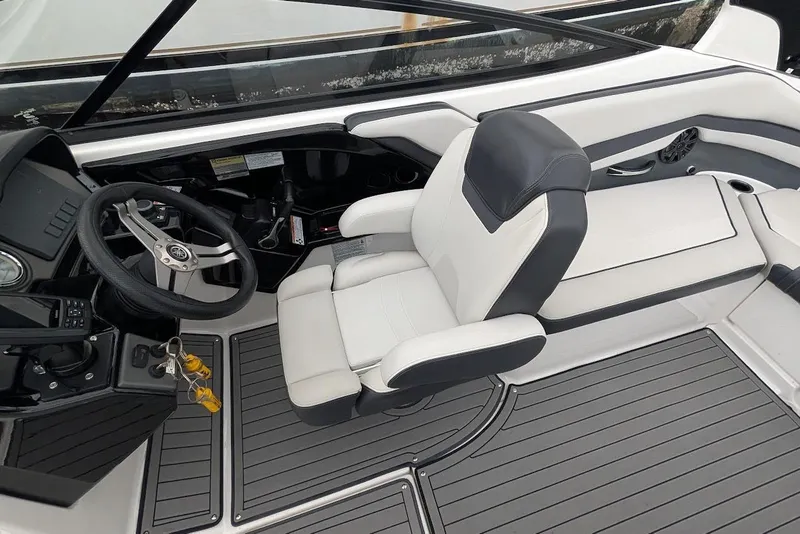 Slide: The Image of 2017 Yamaha 242 Limited S boat interior with steering wheel and seating. - 13