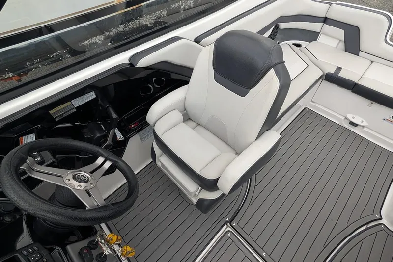 Slide: The Image of 2017 Yamaha 242 Limited S boat interior with steering wheel and seating. - 14