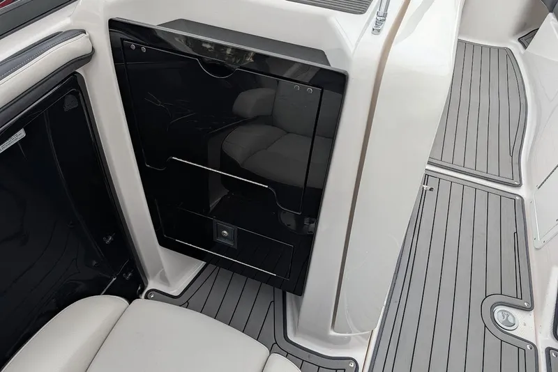 Slide: The Image of 2017 Yamaha 242 Limited S interior with sleek black panel and gray flooring. - 16
