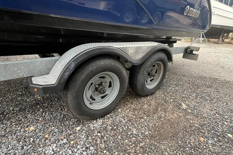 Slide: The Image of Trailer wheels of a 2017 Yamaha 242 Limited S boat on gravel. - 25