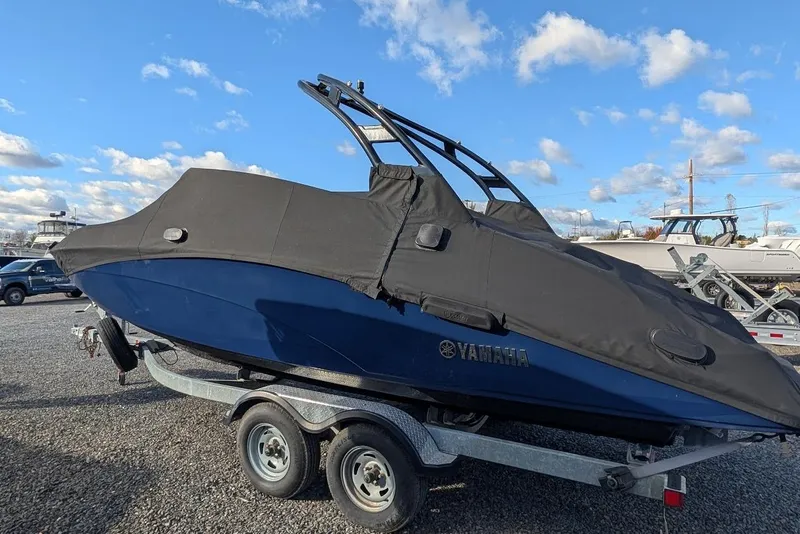 Slide: The Image of 2017 Yamaha 242 Limited S boat covered on trailer, parked outdoors. - 27