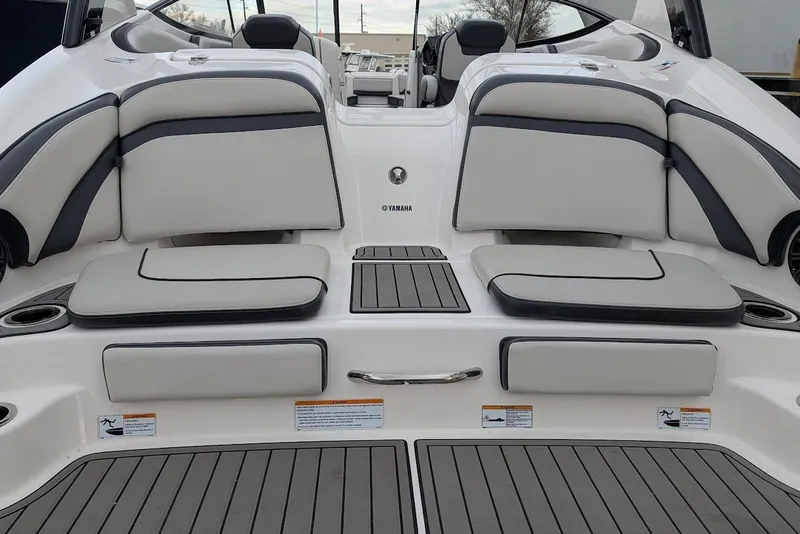Slide: The Image of 2017 Yamaha 242 Limited S boat interior with cushioned seating and sleek design. - 4