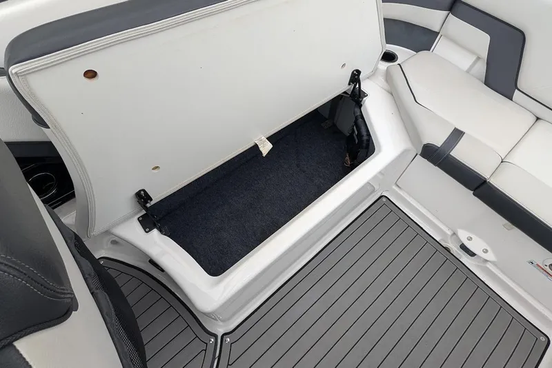 Slide: The Image of Open storage compartment on 2017 Yamaha 242 Limited S boat with cushioned seating. - 8