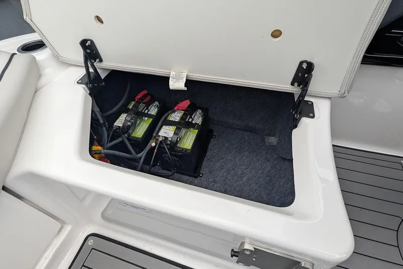 Slide: The Image of 2017 Yamaha 242 Limited S boat battery compartment with two batteries visible. - 9