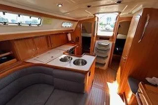 Slide: The Image of Interior of a 2005 Elan 40 yacht with wooden cabinetry and modern amenities. - 13