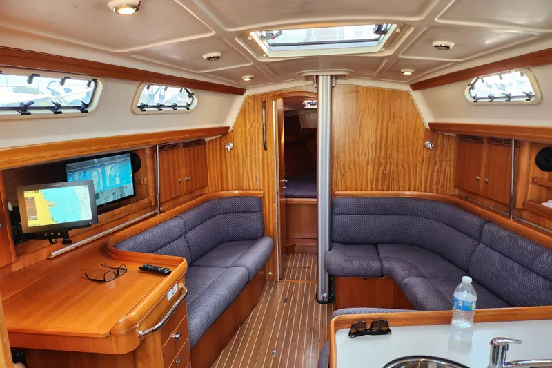 Slide: The Image of Interior of 2005 Elan 40 yacht with cozy seating and navigation equipment. - 16