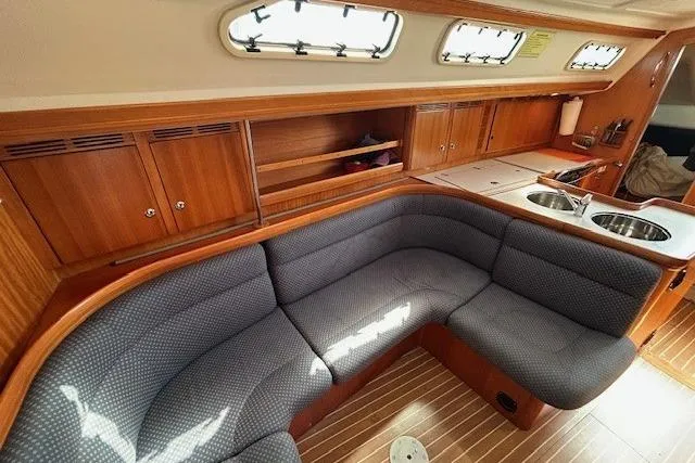 Slide: The Image of Interior of 2005 Elan 40 yacht with cozy seating and wooden cabinetry. - 19